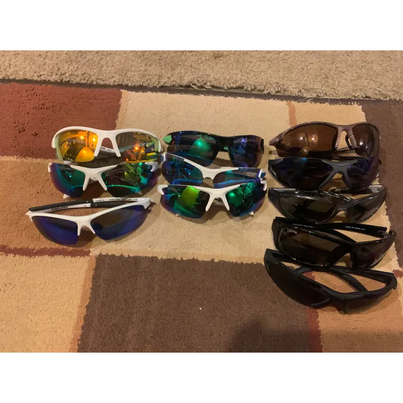 11 pairs of youth baseball sunglasses. various brands. alot of rawlings